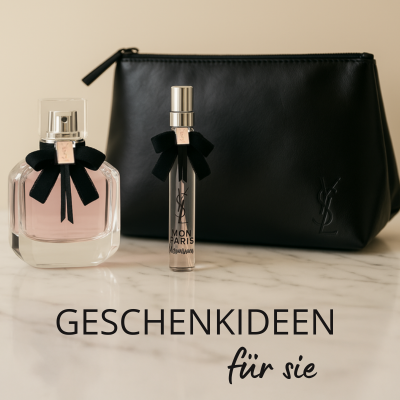 Elegantes Yves Saint Laurent Geschenkset auf Marmoroberfläche: ein Flakon des Parfums „Mon Paris“ mit schwarzer Schleife, ein passender Travel Spray sowie eine schwarze YSL-Kosmetiktasche mit Logo-Prägung. Darunter der Text „Geschenkideen für sie“.